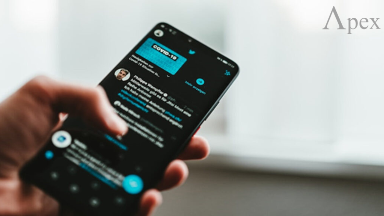 Public Twitter account explained Hand holding a phone showing a public Twitter feed in the app.